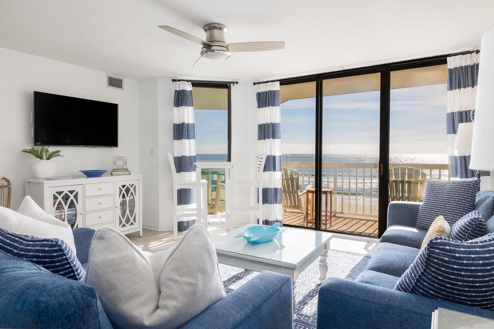 Bright seaside living room with balcony.