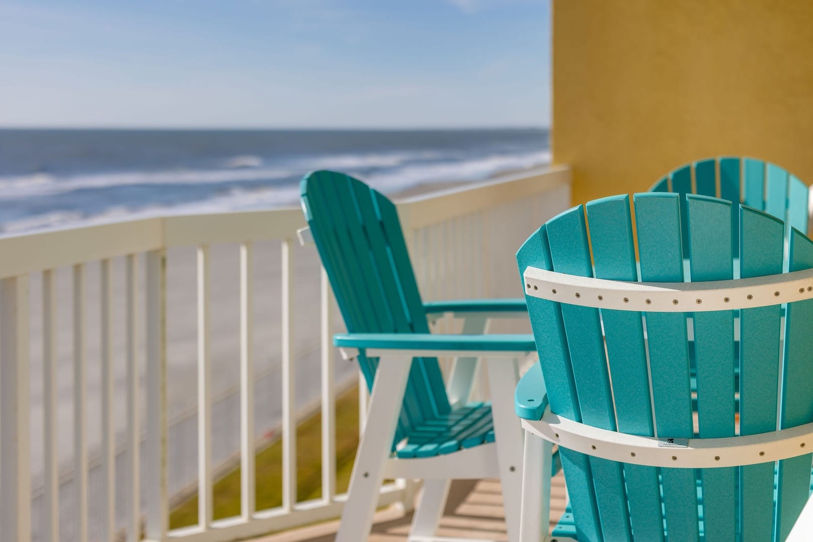 Beach view with turquoise chairs.