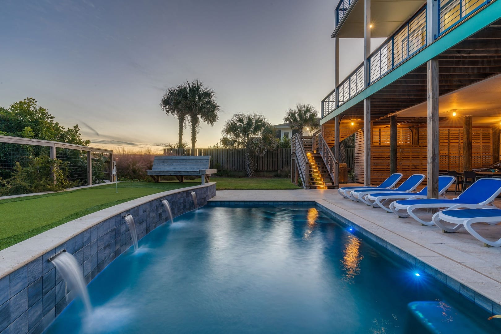 Backyard pool with lounge chairs.