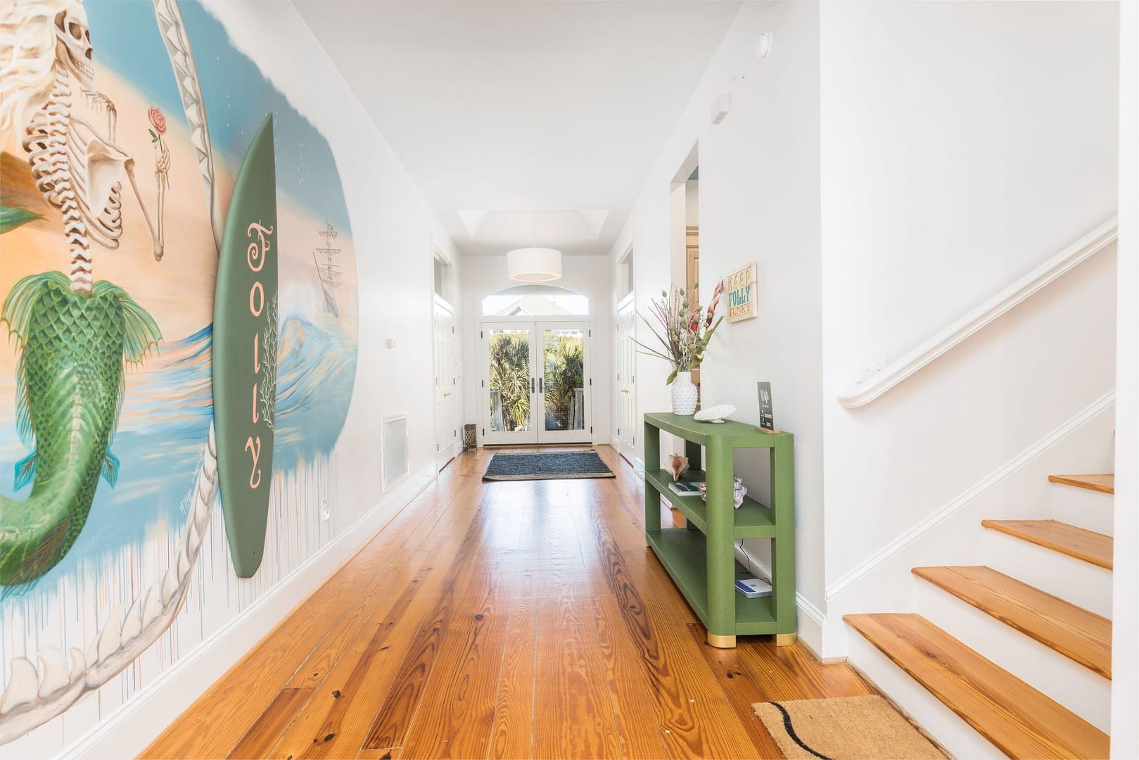 Hallway with mural and decor.