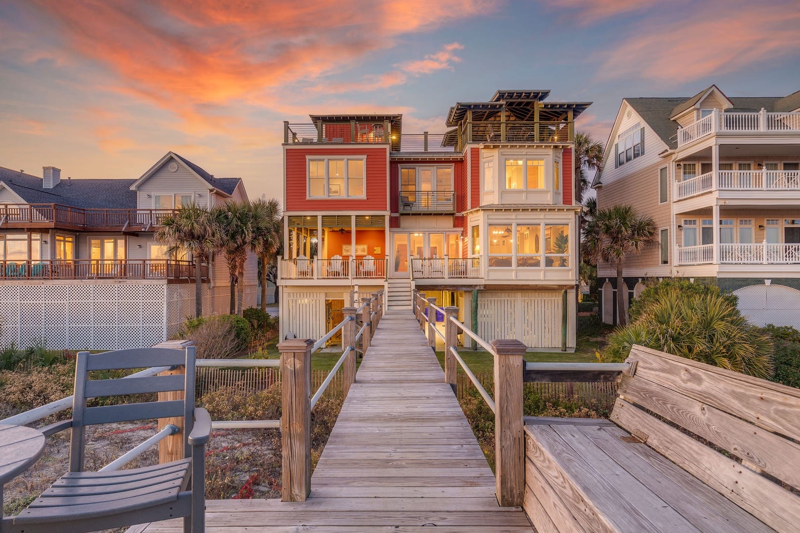 Beach house at sunset with boardwalk.