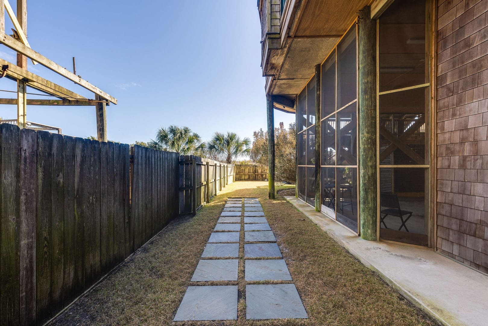 Pathway between house and fence.