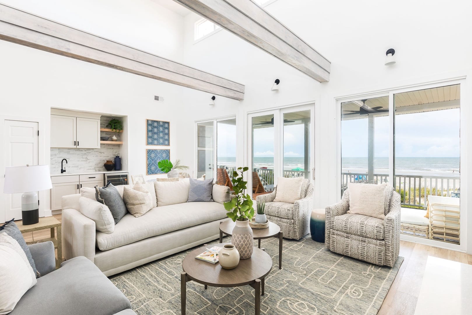 Beachfront living room with large windows.