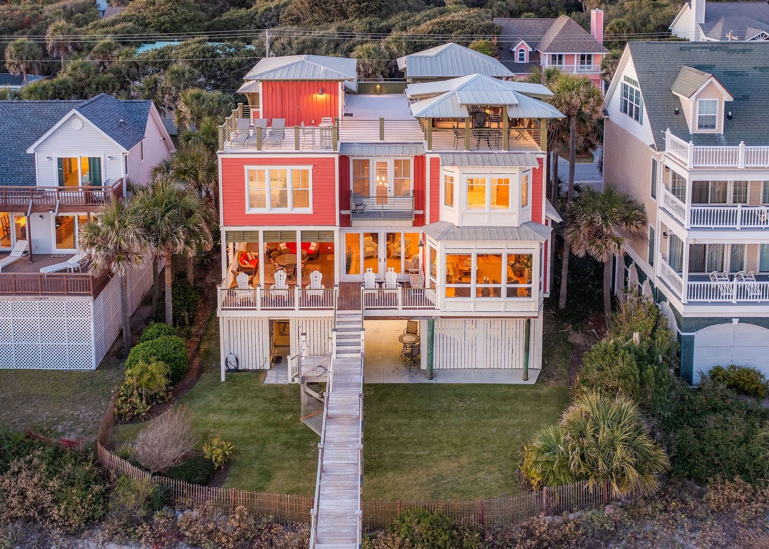 Red beachfront house with balconies.