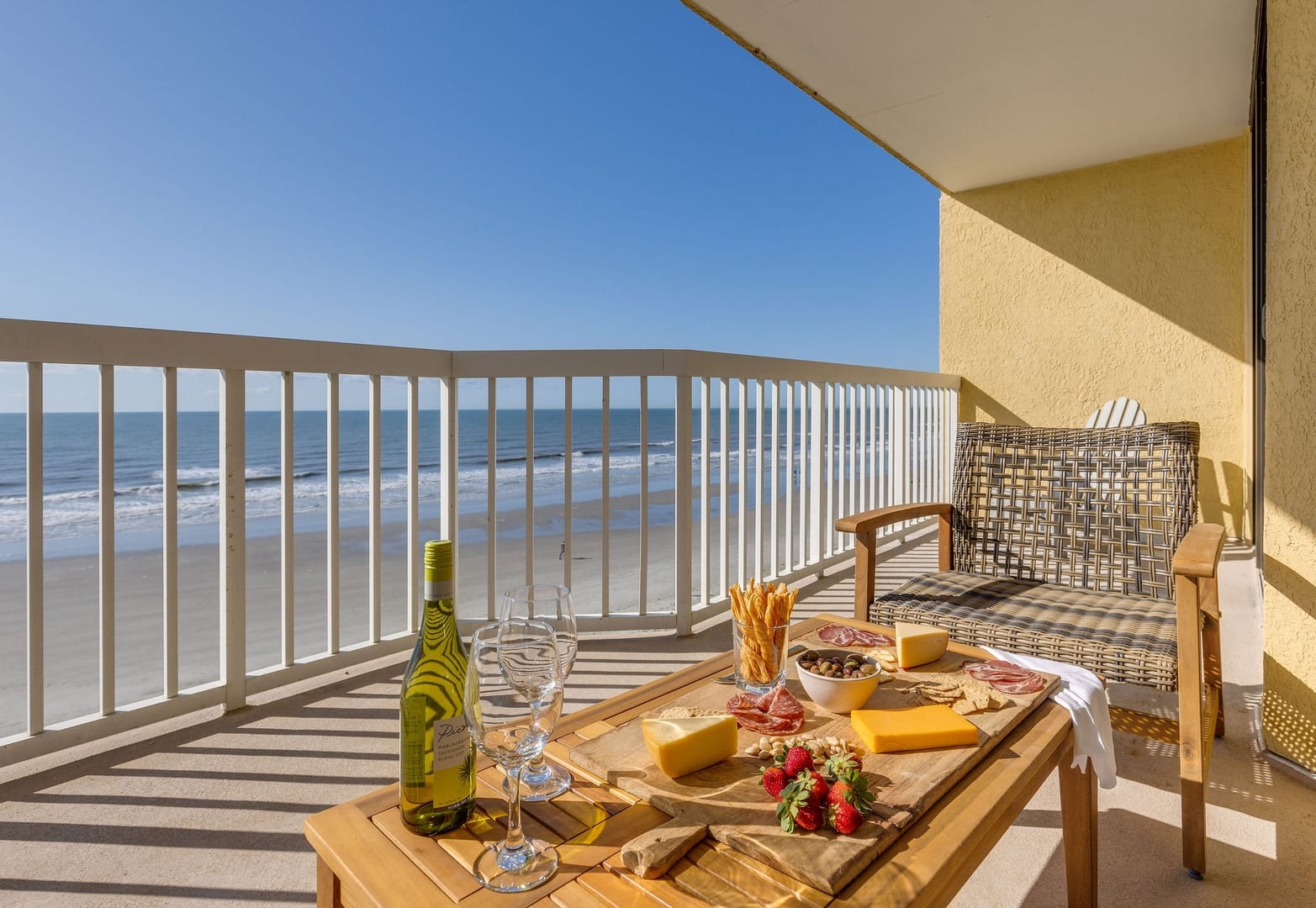 Beachfront balcony with charcuterie spread.