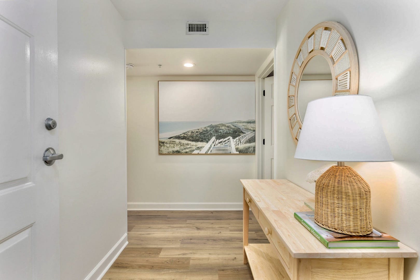 Hallway with lamp and artwork.