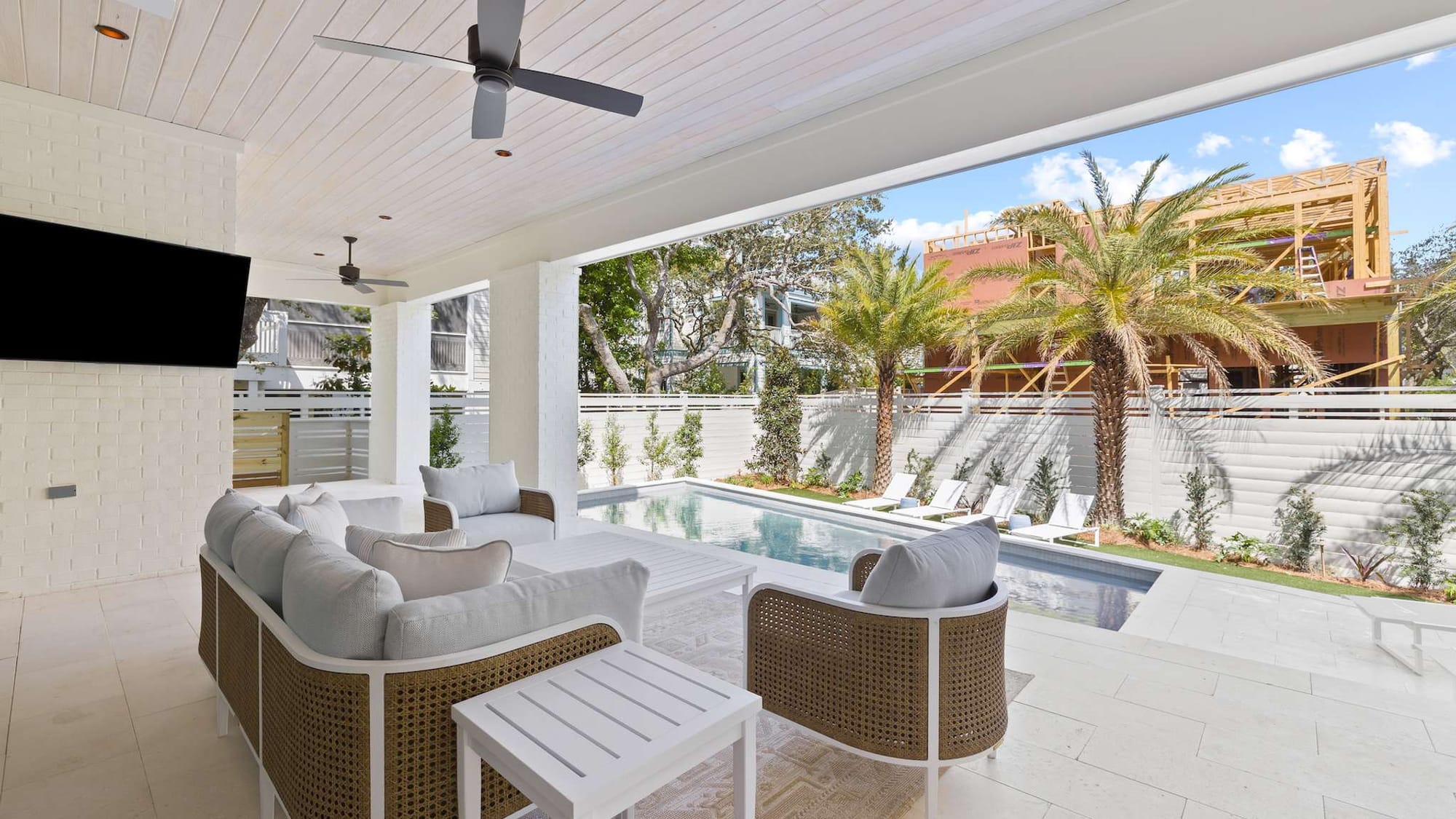 Patio with seating overlooking pool.