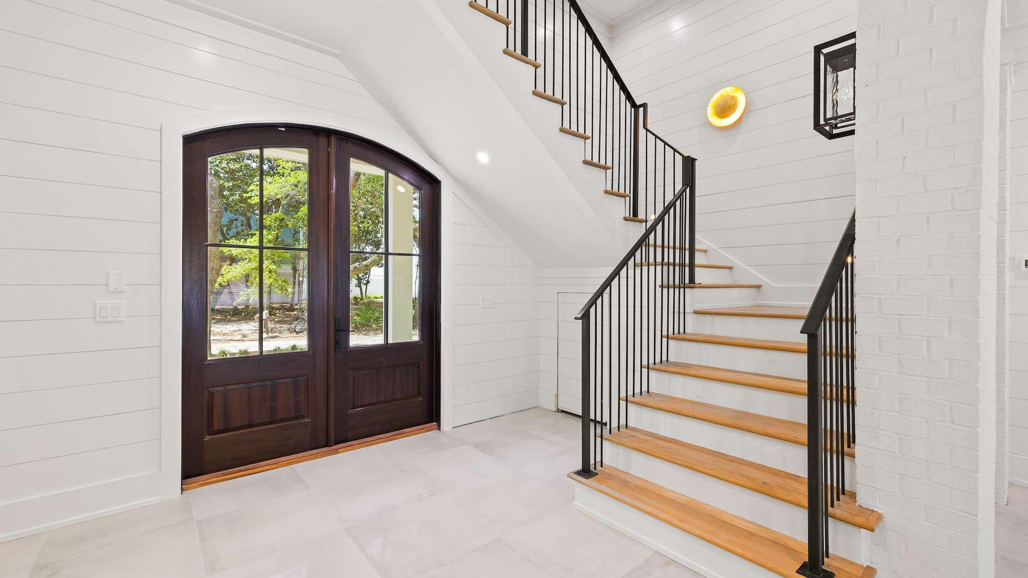 Entryway with staircase and door.