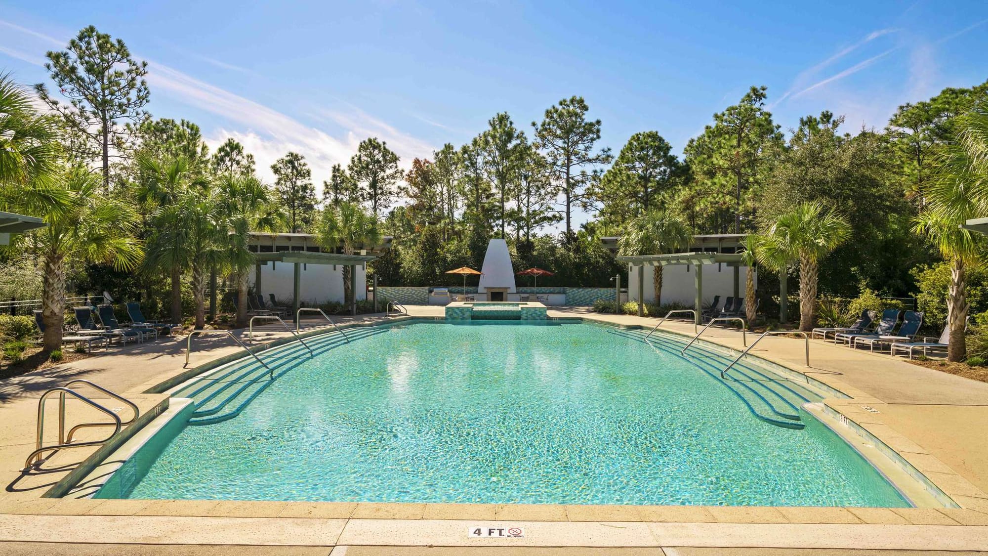 Outdoor pool with surrounding trees.