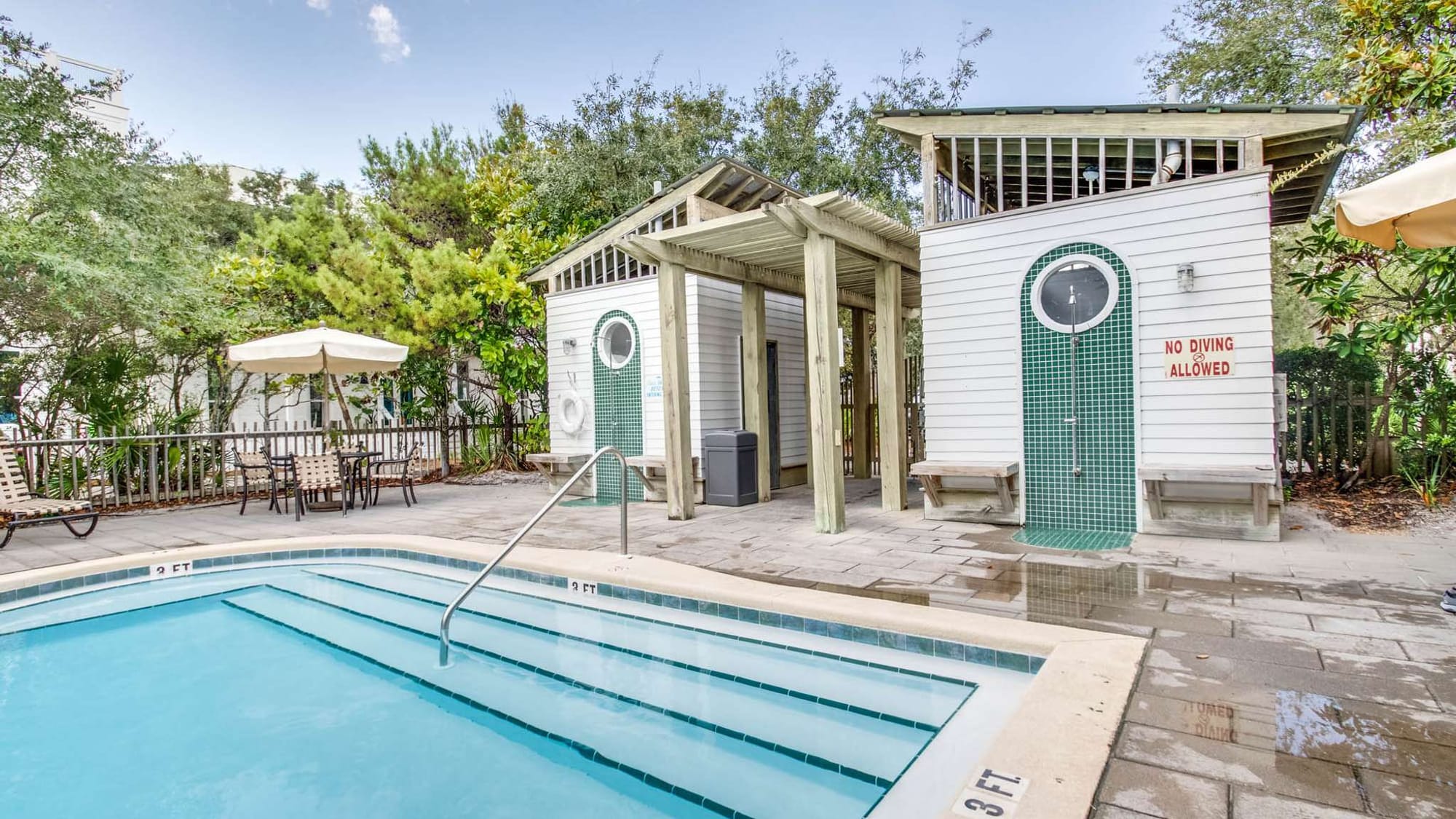 Outdoor pool area with seating.