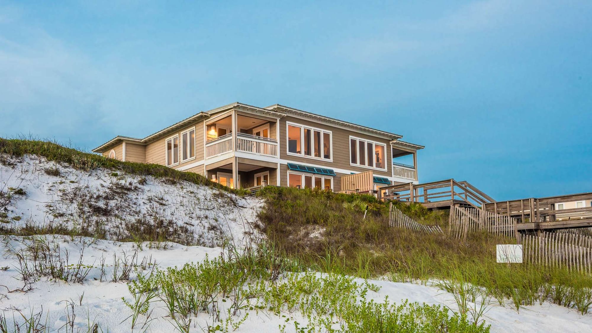 Beachfront house with sand dunes.