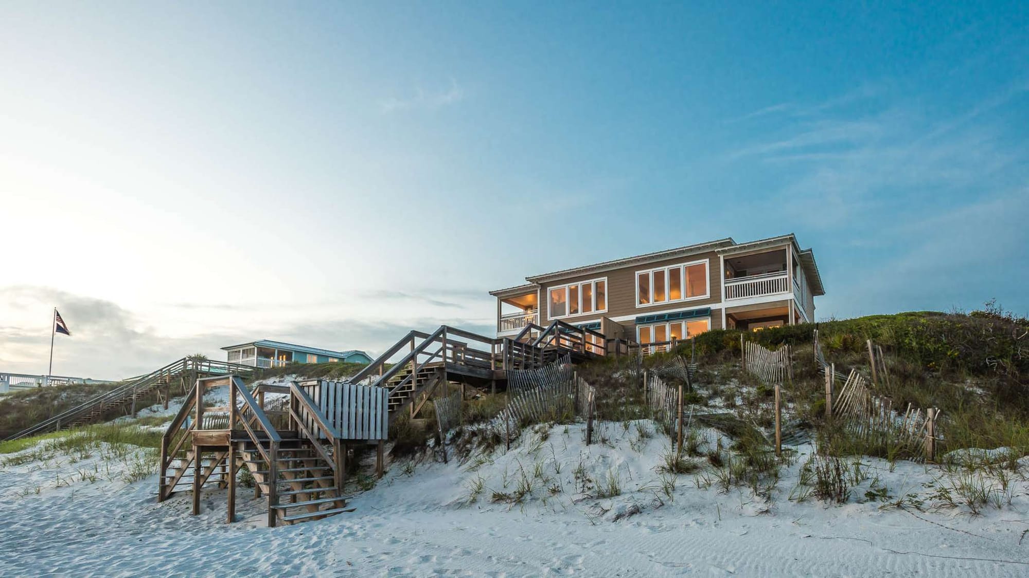 Beach house with sandy dunes.