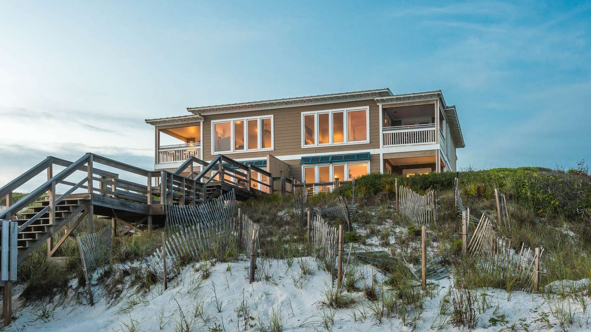 Beachfront house with wooden stairs.