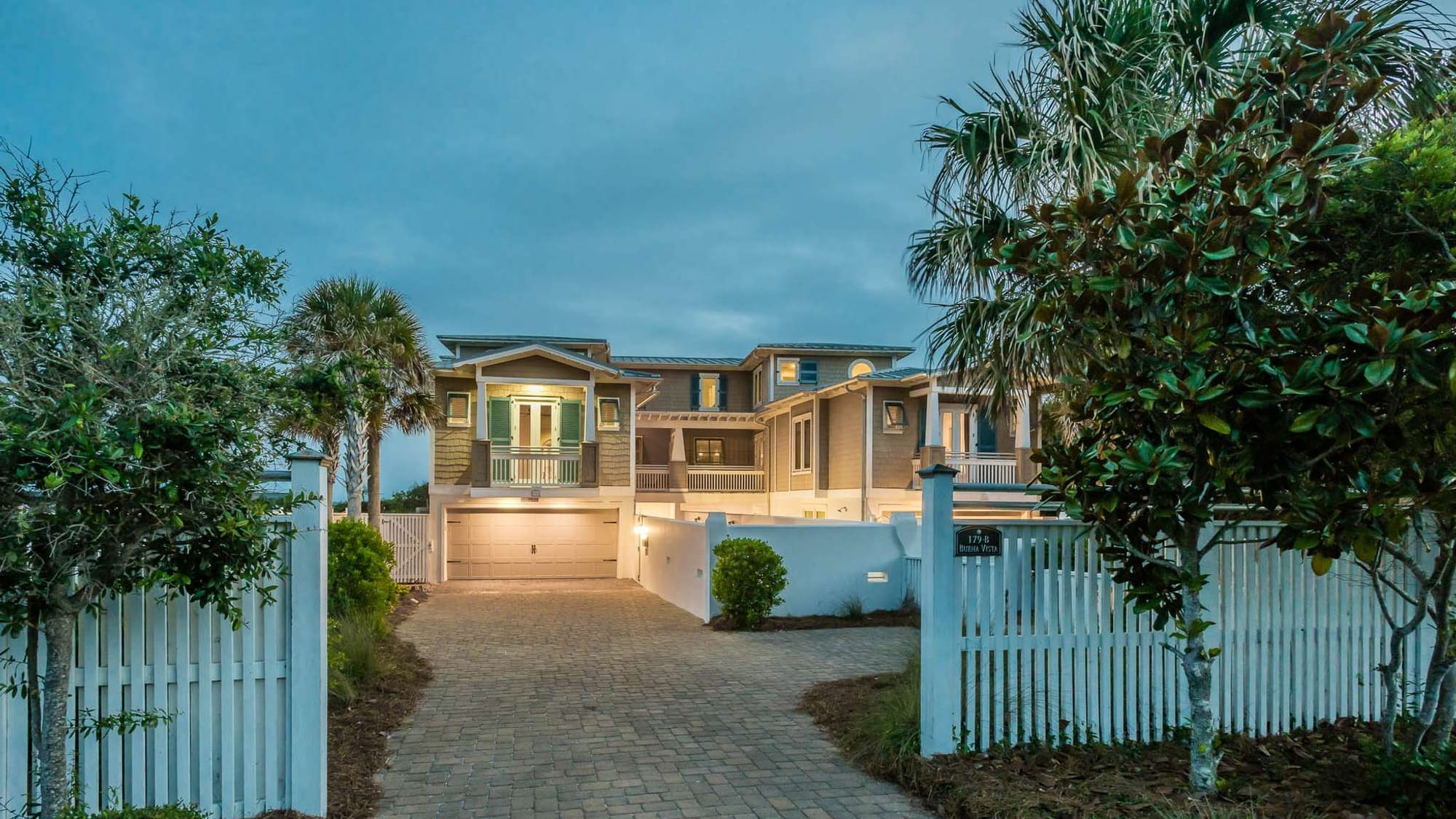 Large house with palm trees.