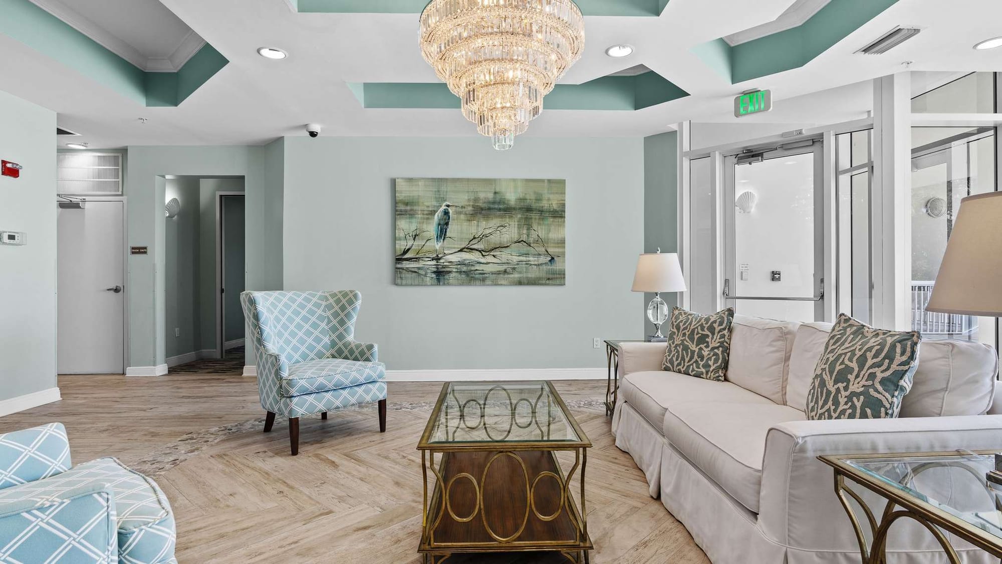 Elegant lobby with chandelier, seating.