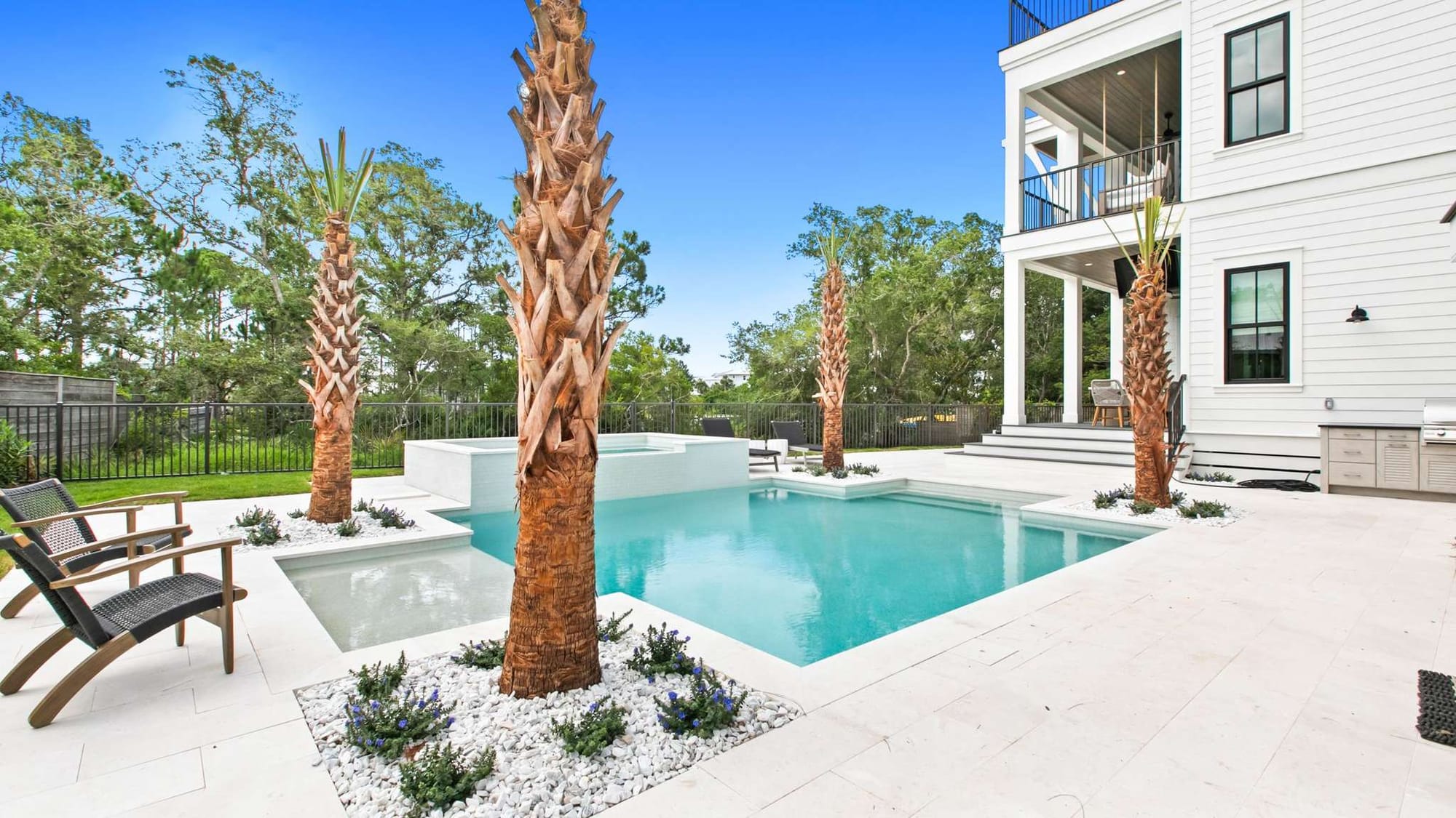 Modern pool area with palm trees.