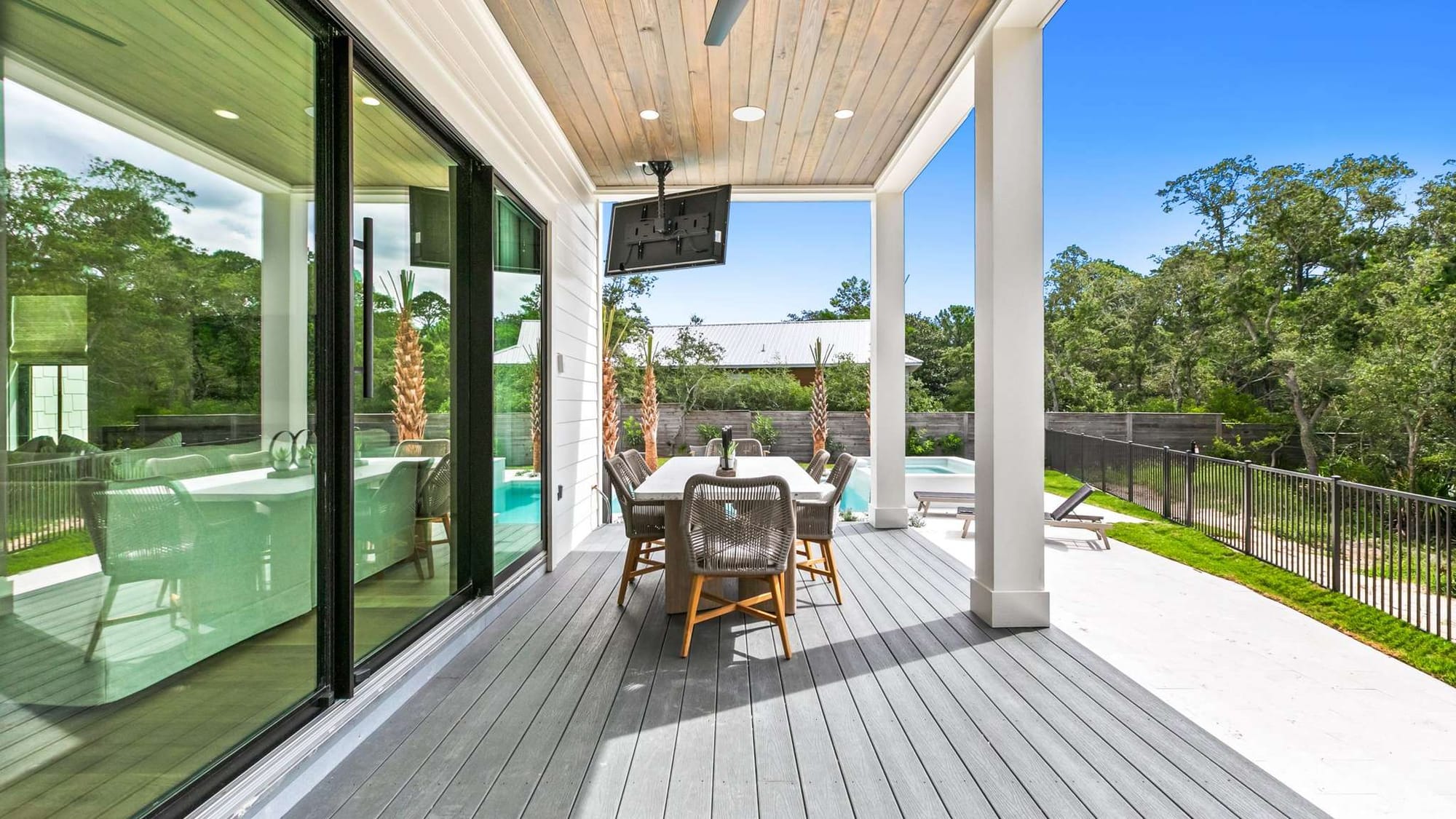 Outdoor patio with table and pool.