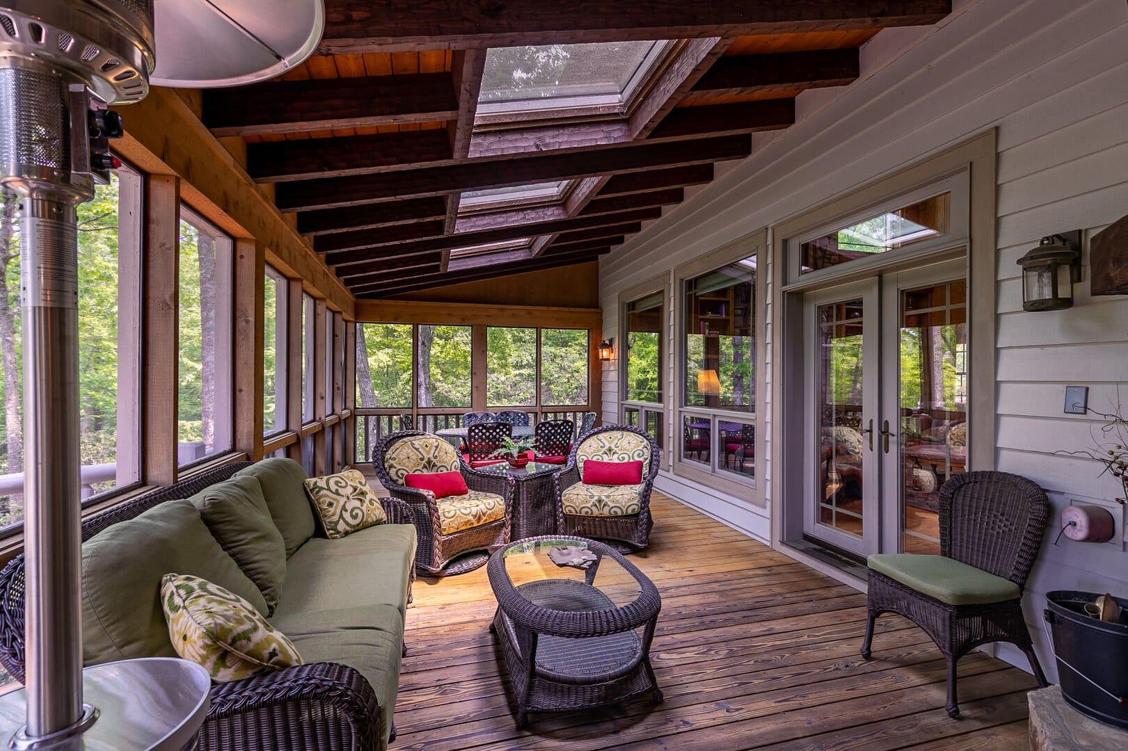 Cozy screened porch with furniture.