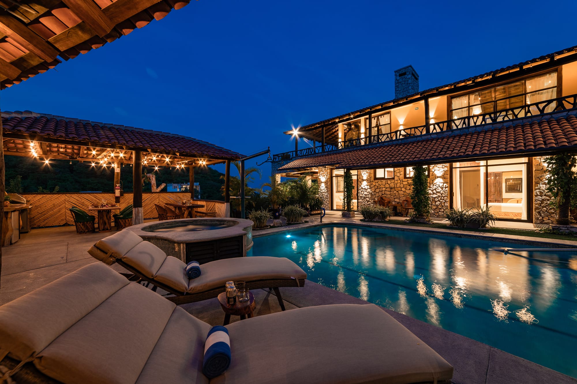 Luxurious villa with pool at night.