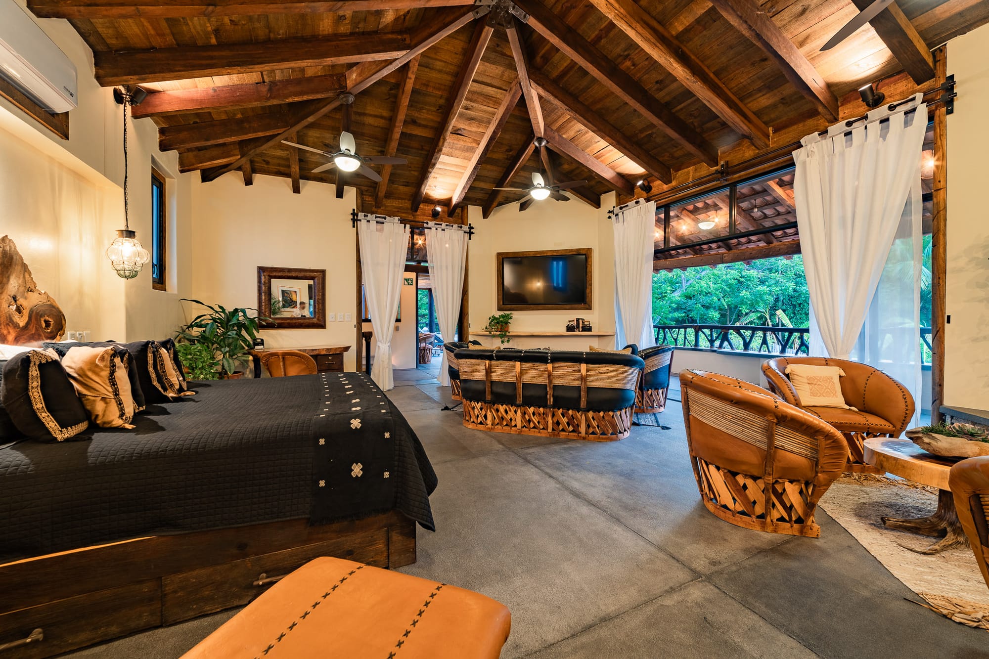 Rustic bedroom with wooden ceiling.