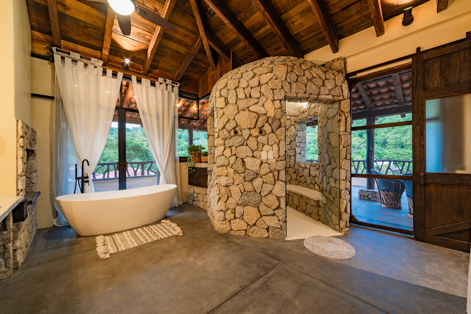 Rustic bathroom with stone shower.