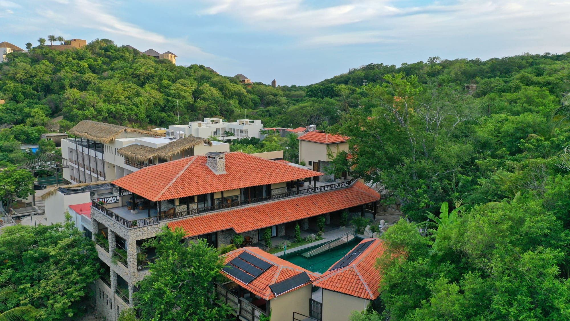 Hillside house with red roof.