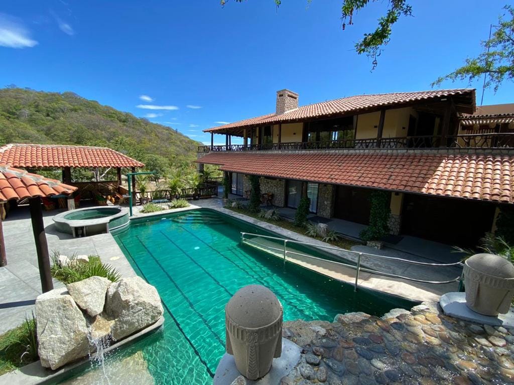 House with pool and mountains.