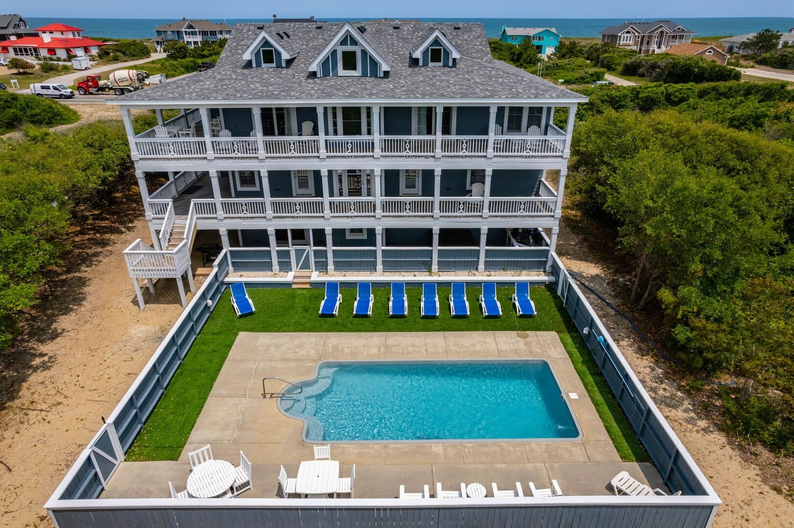 Three-story house with backyard pool.