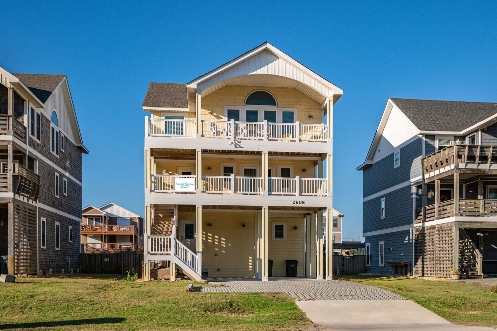 Three-story beach house with balconies.