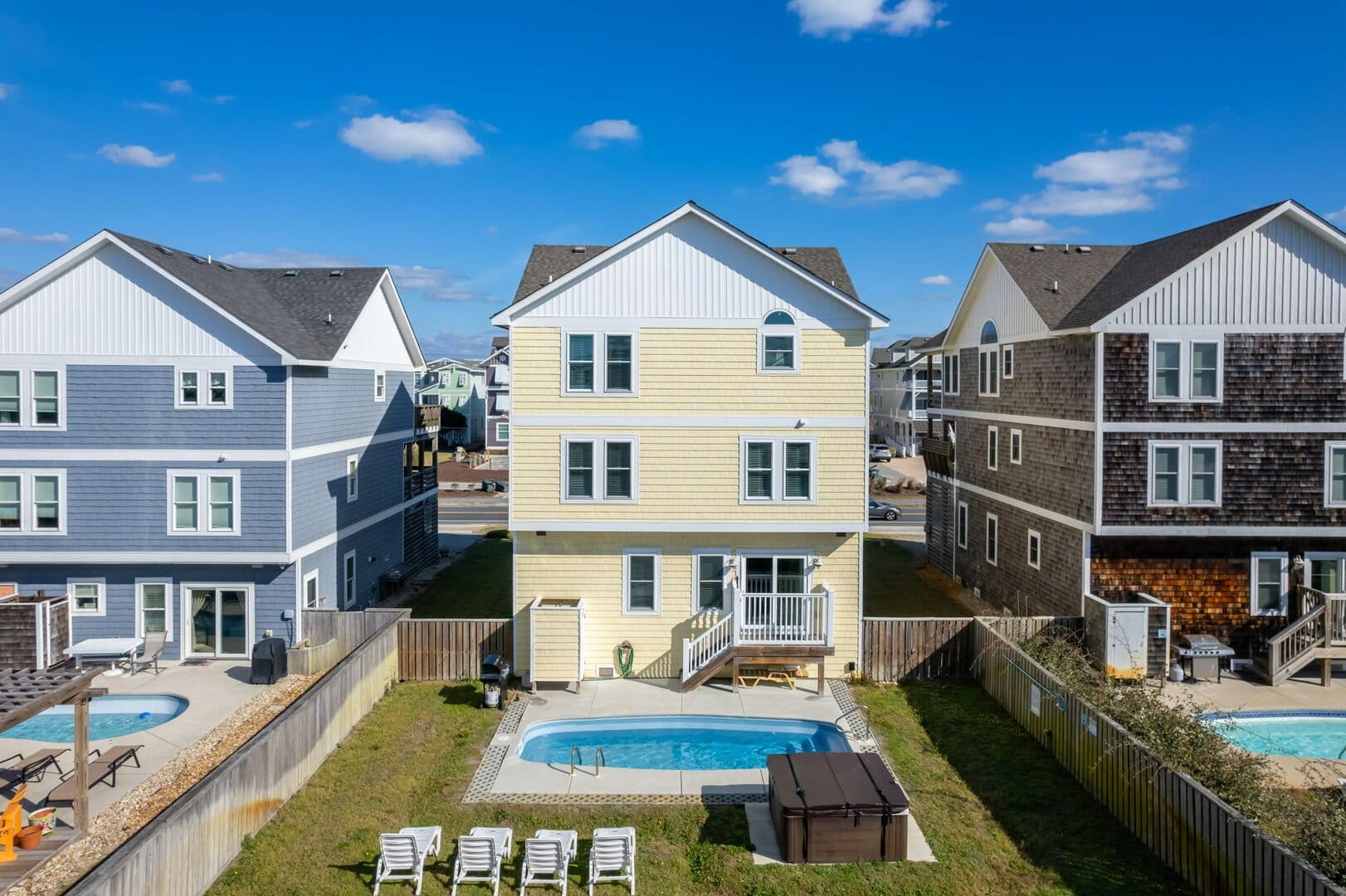 Three houses with backyard pools.