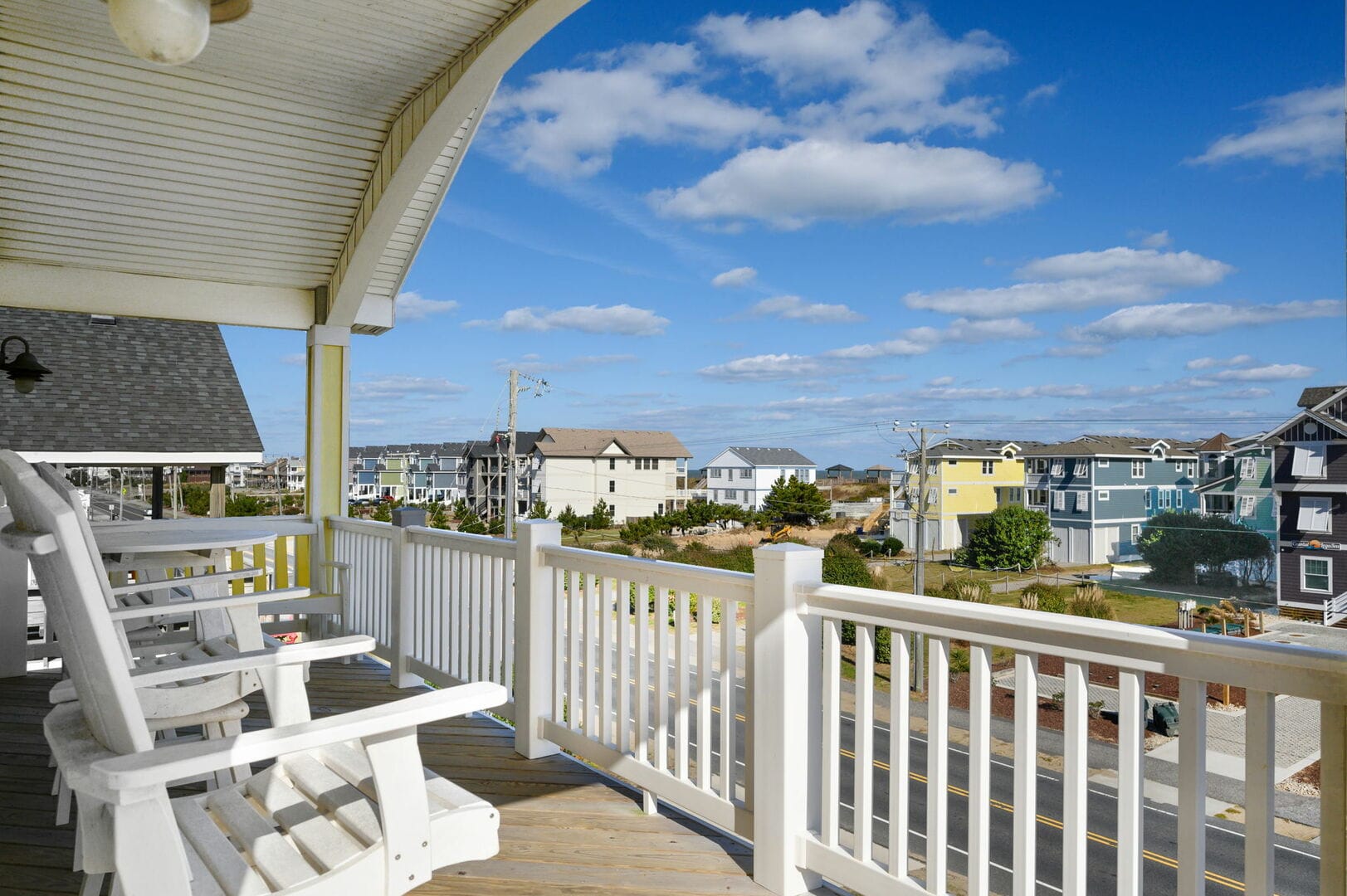 Porch with rocking chairs, scenic view.