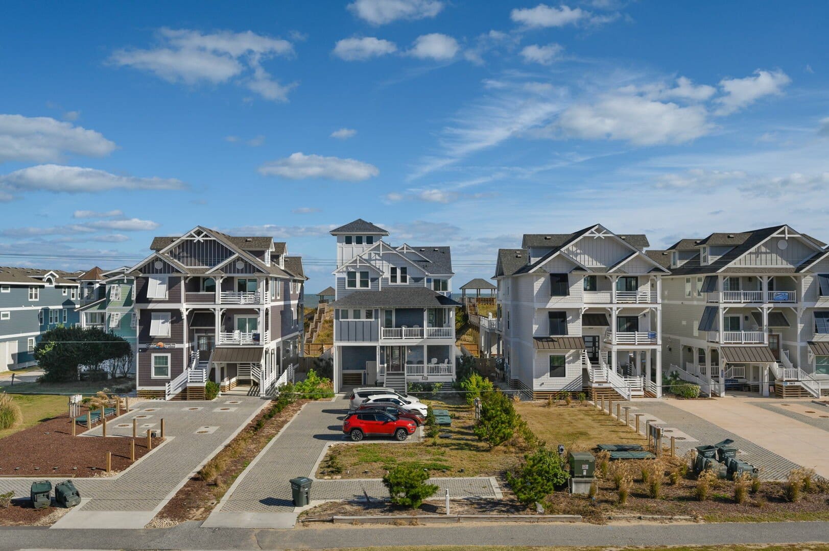 Beachside houses under blue sky.