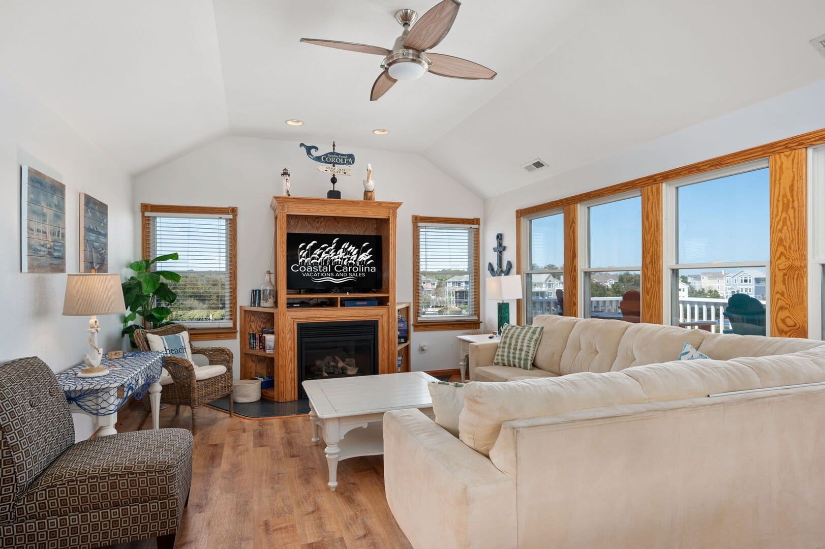 Coastal-themed living room with windows.