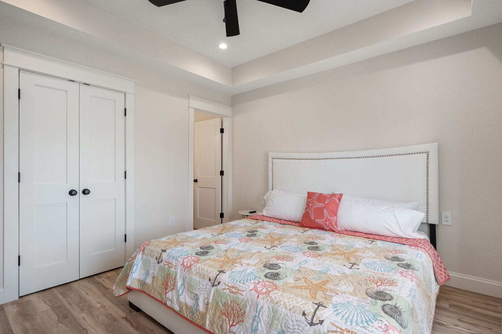 Coastal-themed bedroom with colorful bedding.