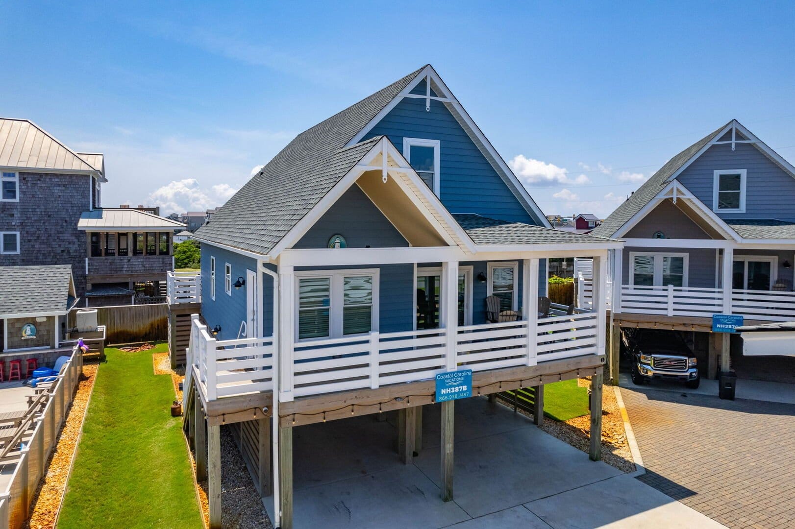 Blue coastal house with porch.