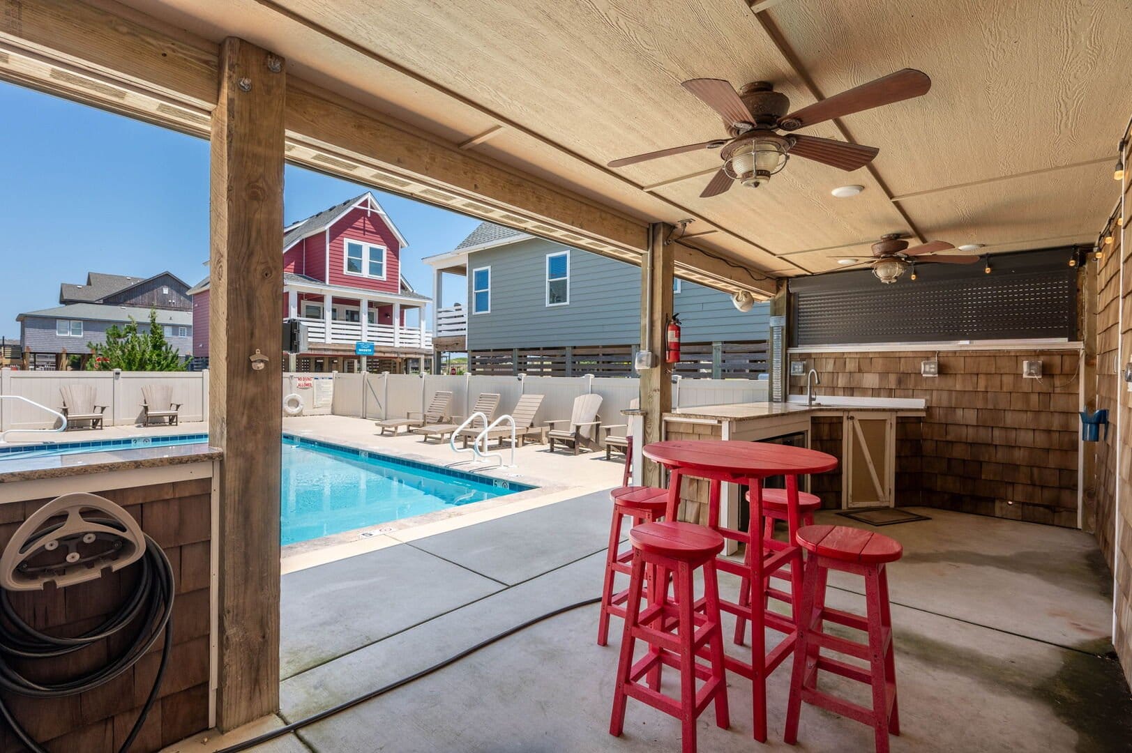 Covered patio overlooking swimming pool.