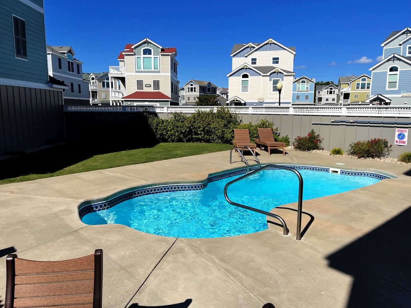 Outdoor swimming pool and surrounding houses.