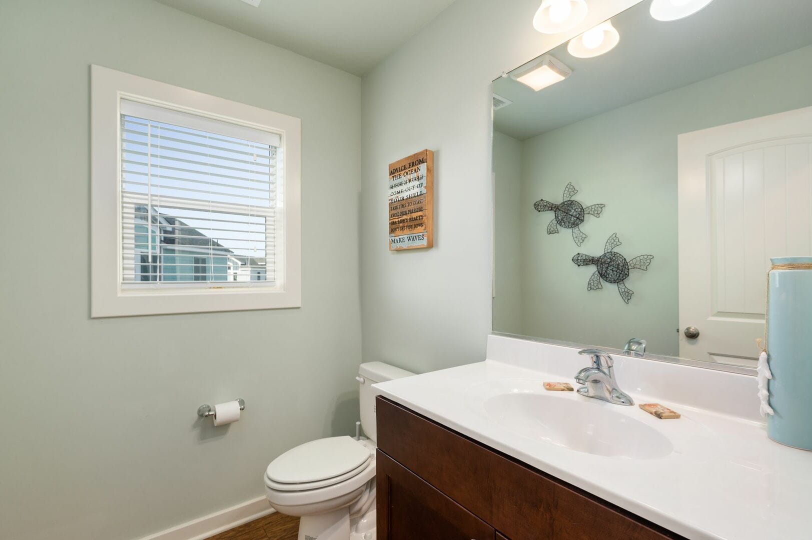 Bathroom with window and mirror.