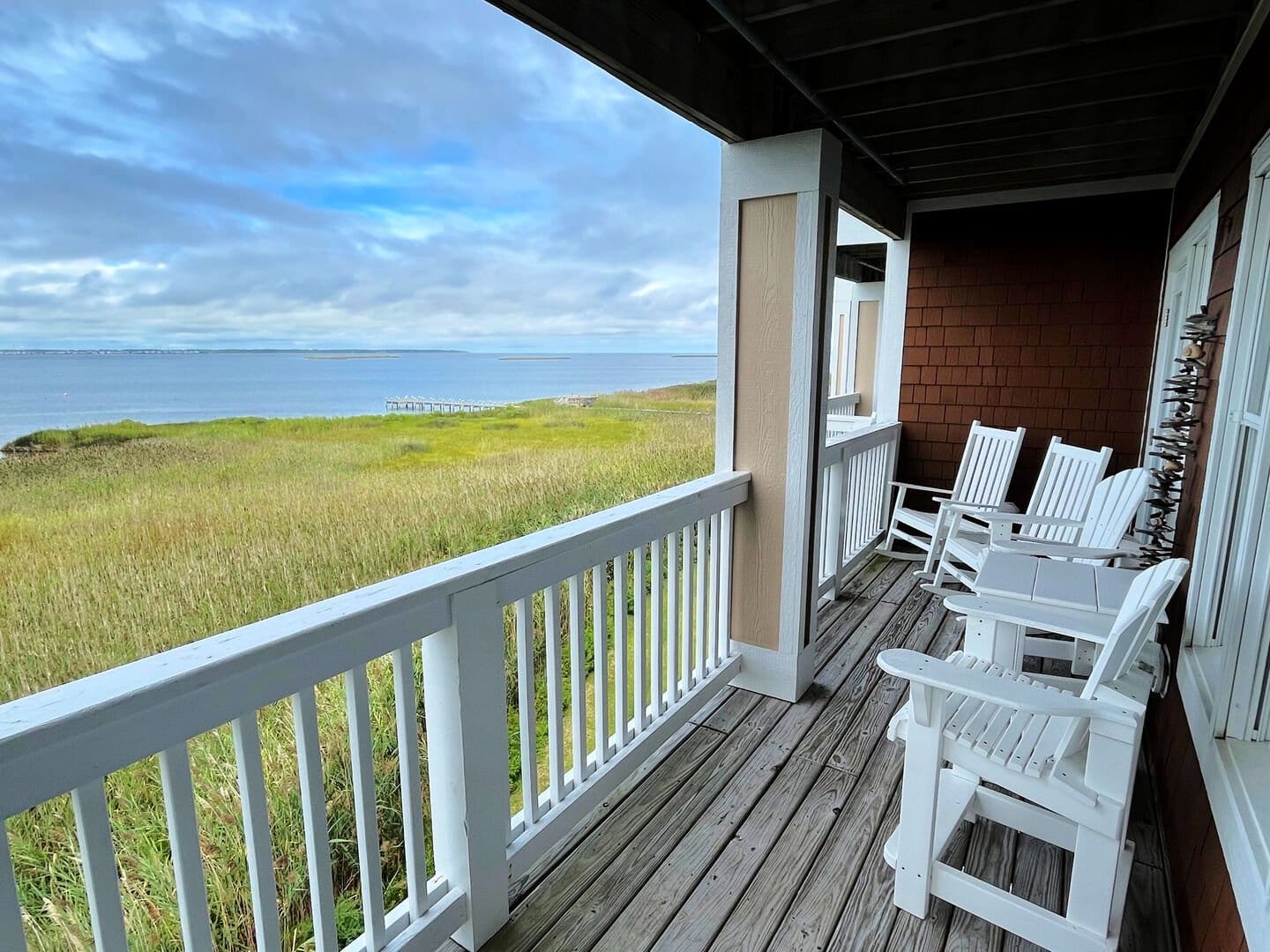 Porch with chairs overlooking ocean.