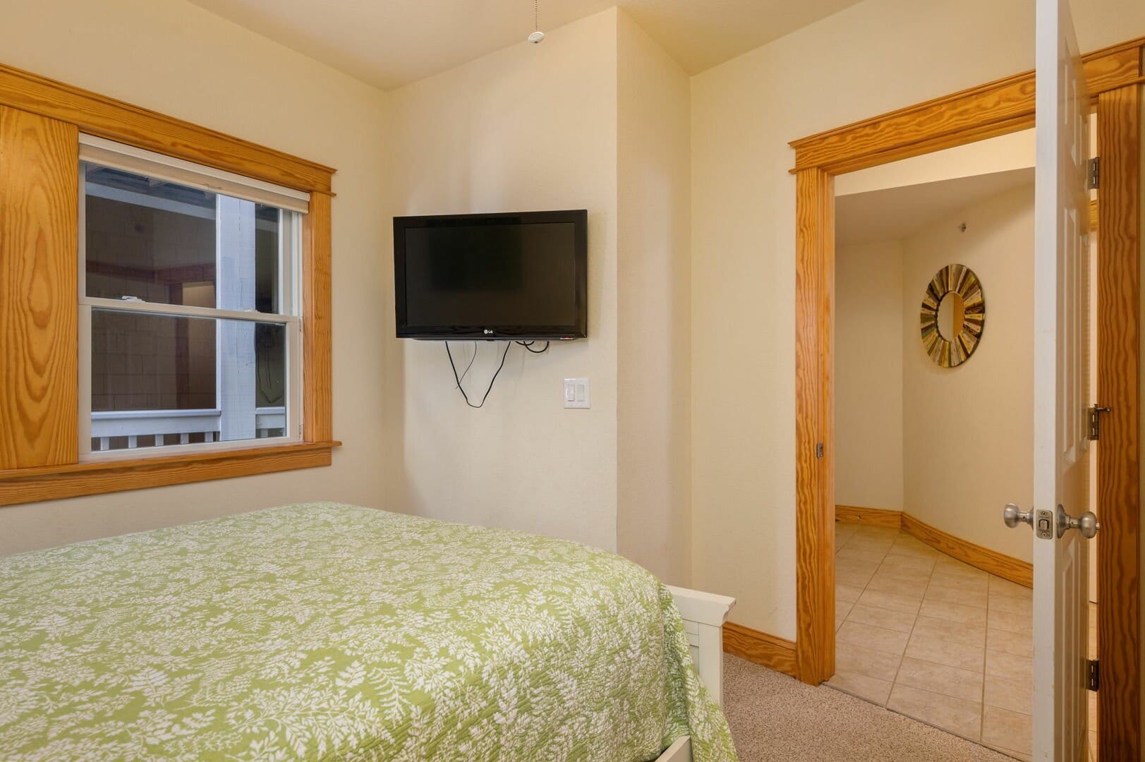 Bedroom with TV and window.