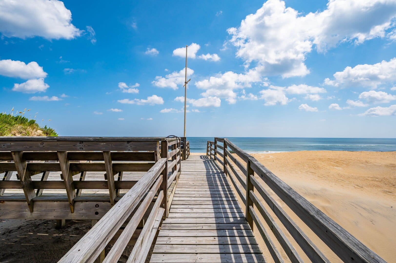 Wooden boardwalk leading to beach.