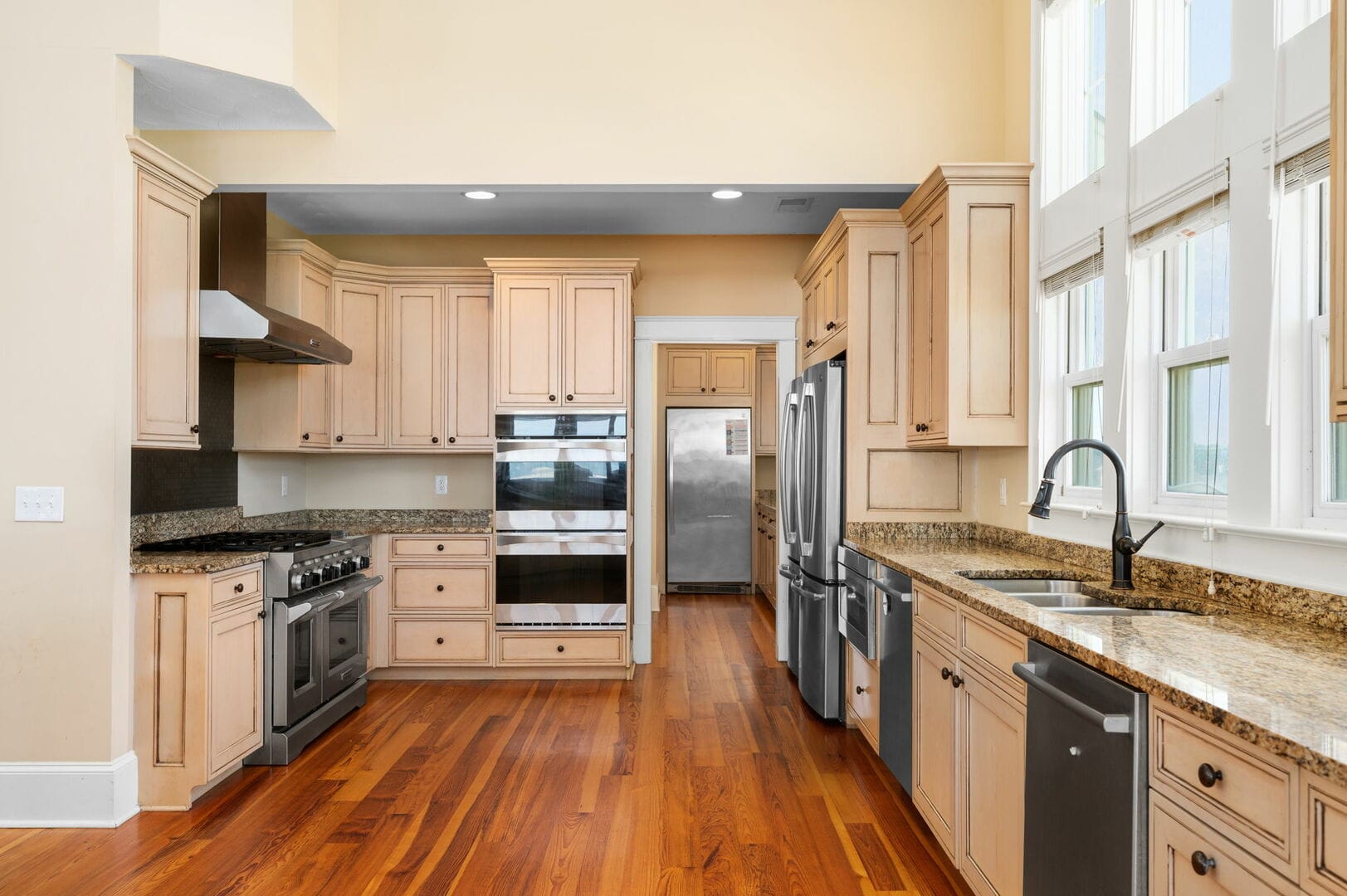 Spacious kitchen with wooden cabinets.