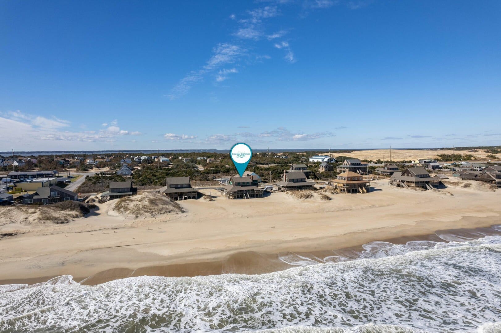 Beachfront houses and ocean waves.