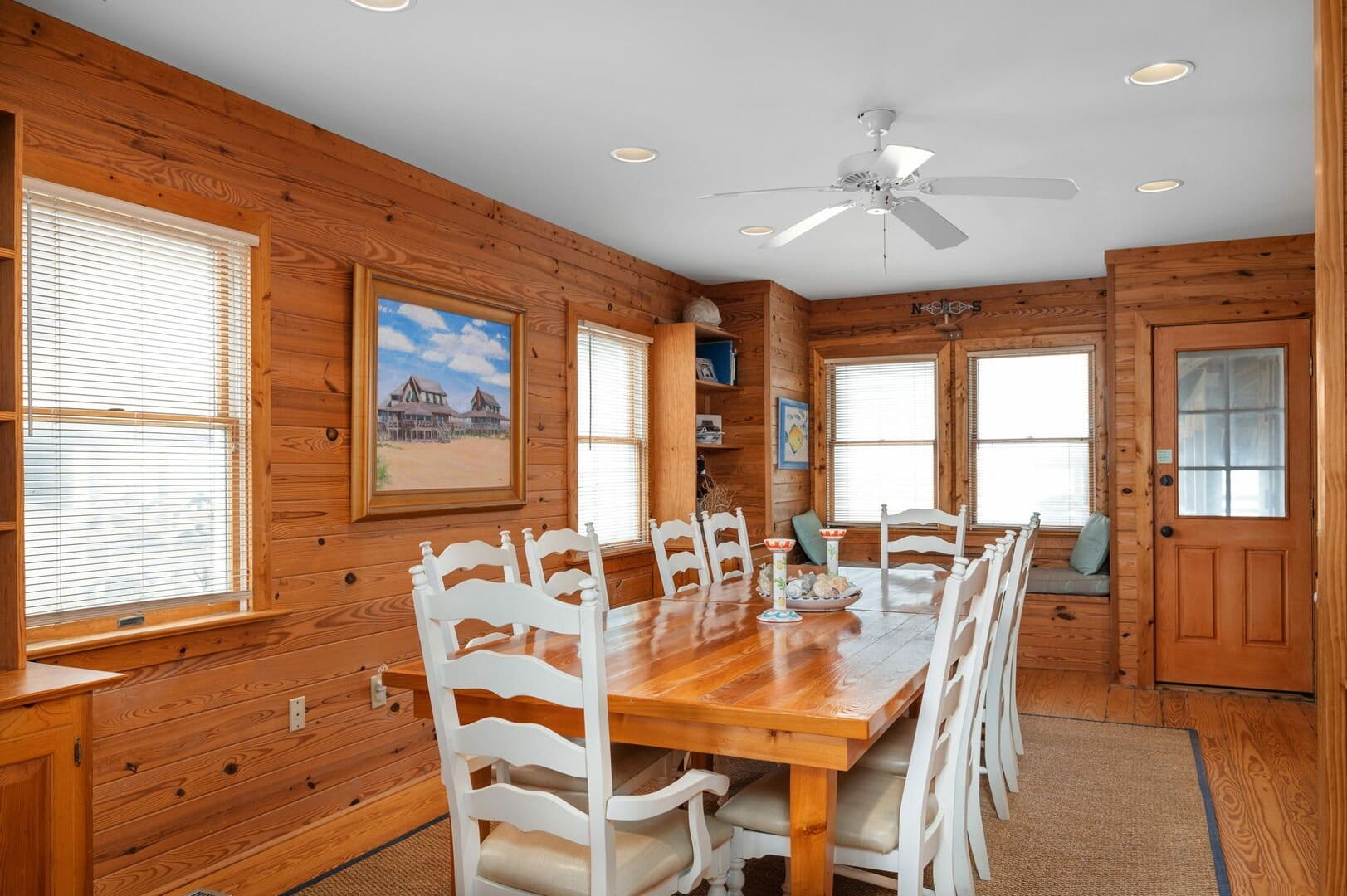 Rustic dining room with wood walls.