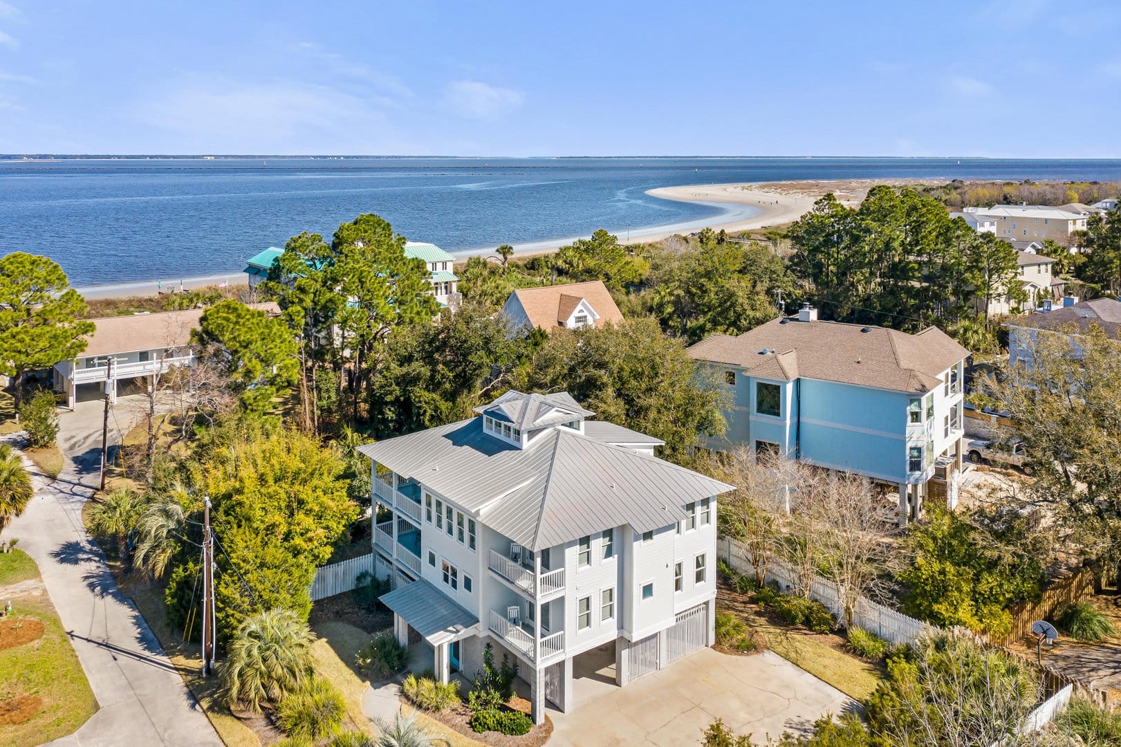 Coastal houses near a sandy beach.