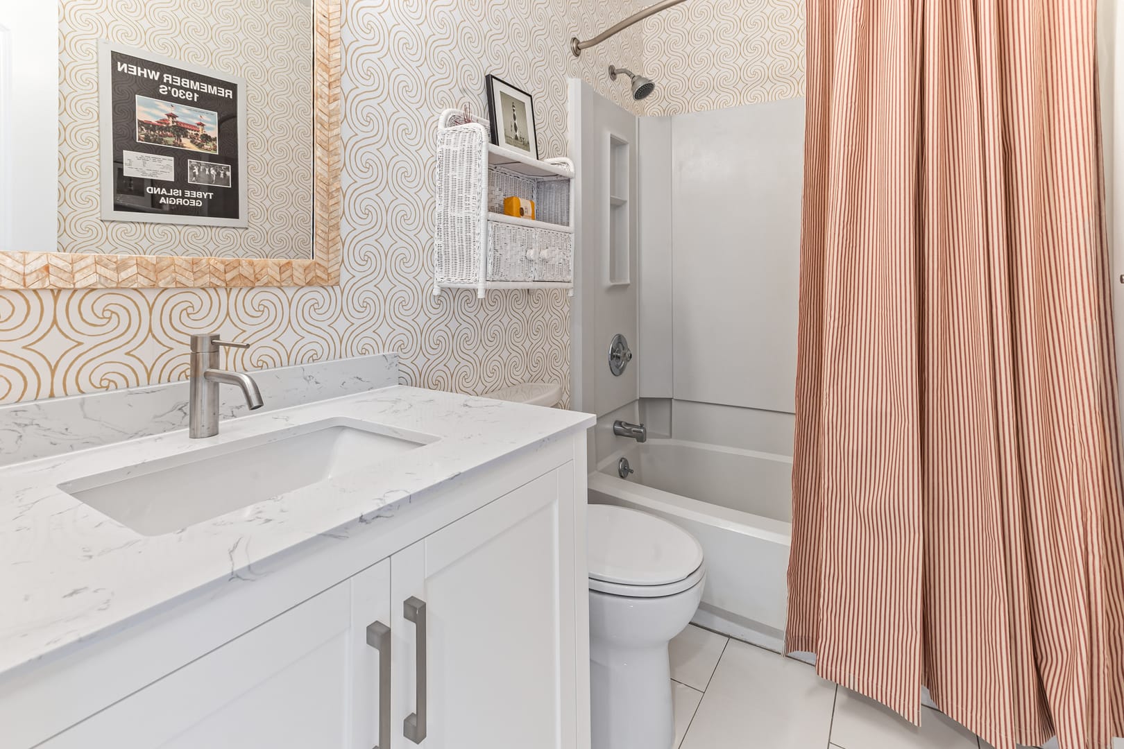 Modern bathroom with orange shower curtain.