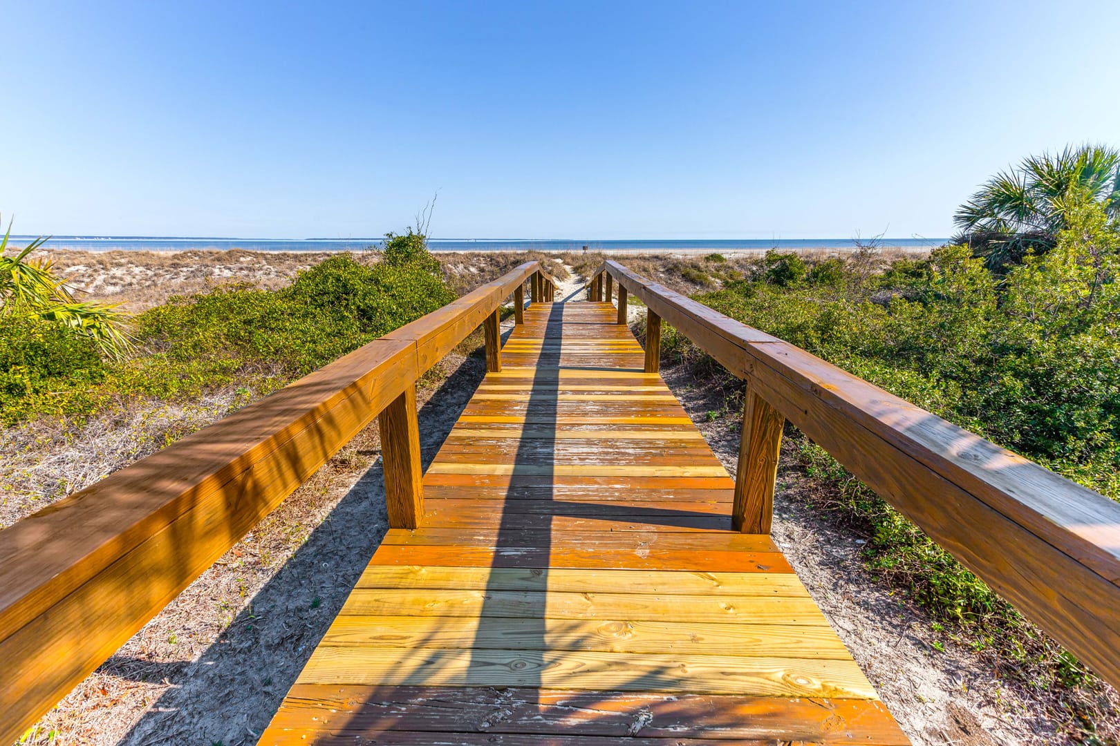 Wooden boardwalk leading to beach.