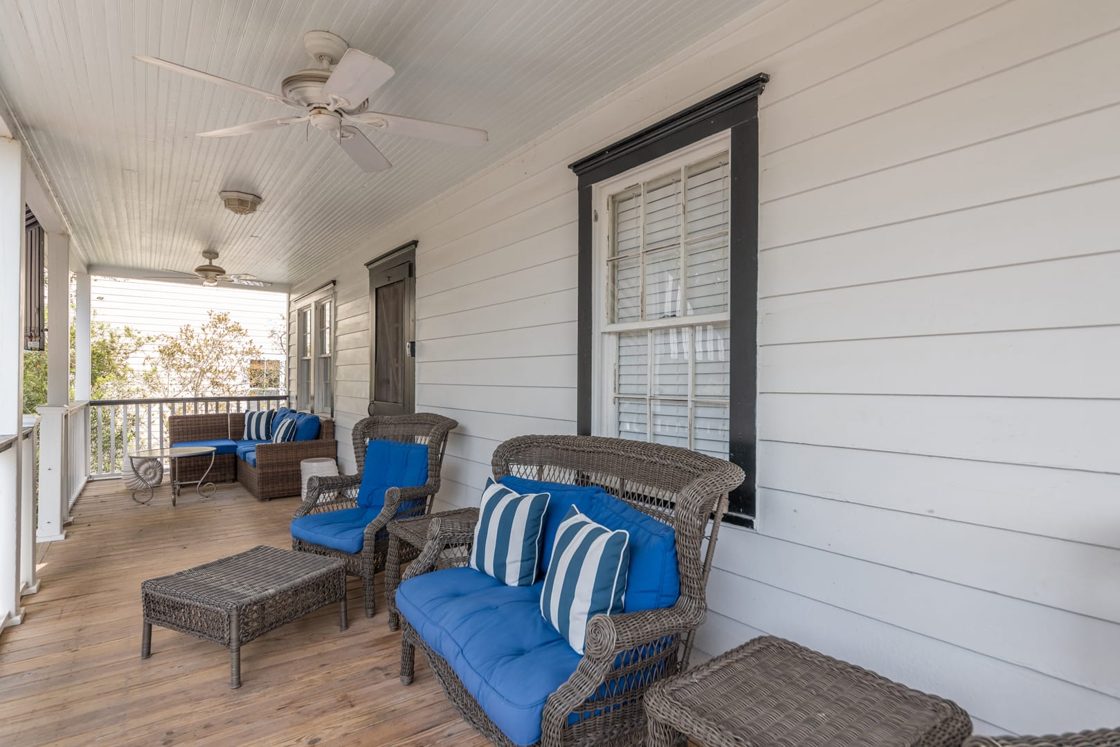 Outdoor porch with wicker furniture.