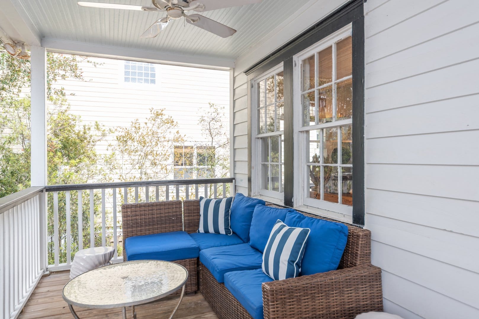 Porch with blue cushioned furniture.