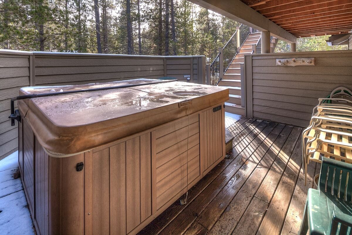 Outdoor hot tub on wooden deck.